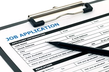Employment Application - image of job application form on clipboard - Encompass Community Supports