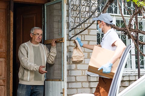 Home Delivered Meals for adults over 60 - image of food delivery at senior's home - Encompass Community Supports
