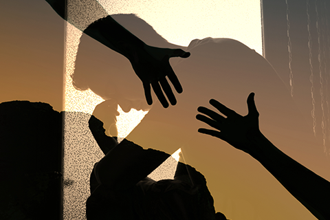 Prevention Services (for the prevention of suicide and substance use) - image of hands reaching for each other over faded image of person struggling - Encompass Community Supports